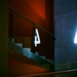 Artistic view of interior stairs with illuminated number four in St. Petersburg.