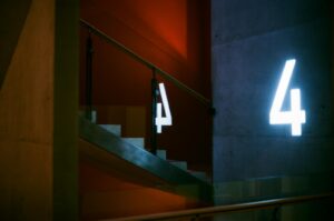 Artistic view of interior stairs with illuminated number four in St. Petersburg.