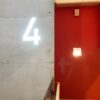 Contemporary interior featuring an illuminated number 4 on a concrete wall in Sankt-Peterburg, Russia.