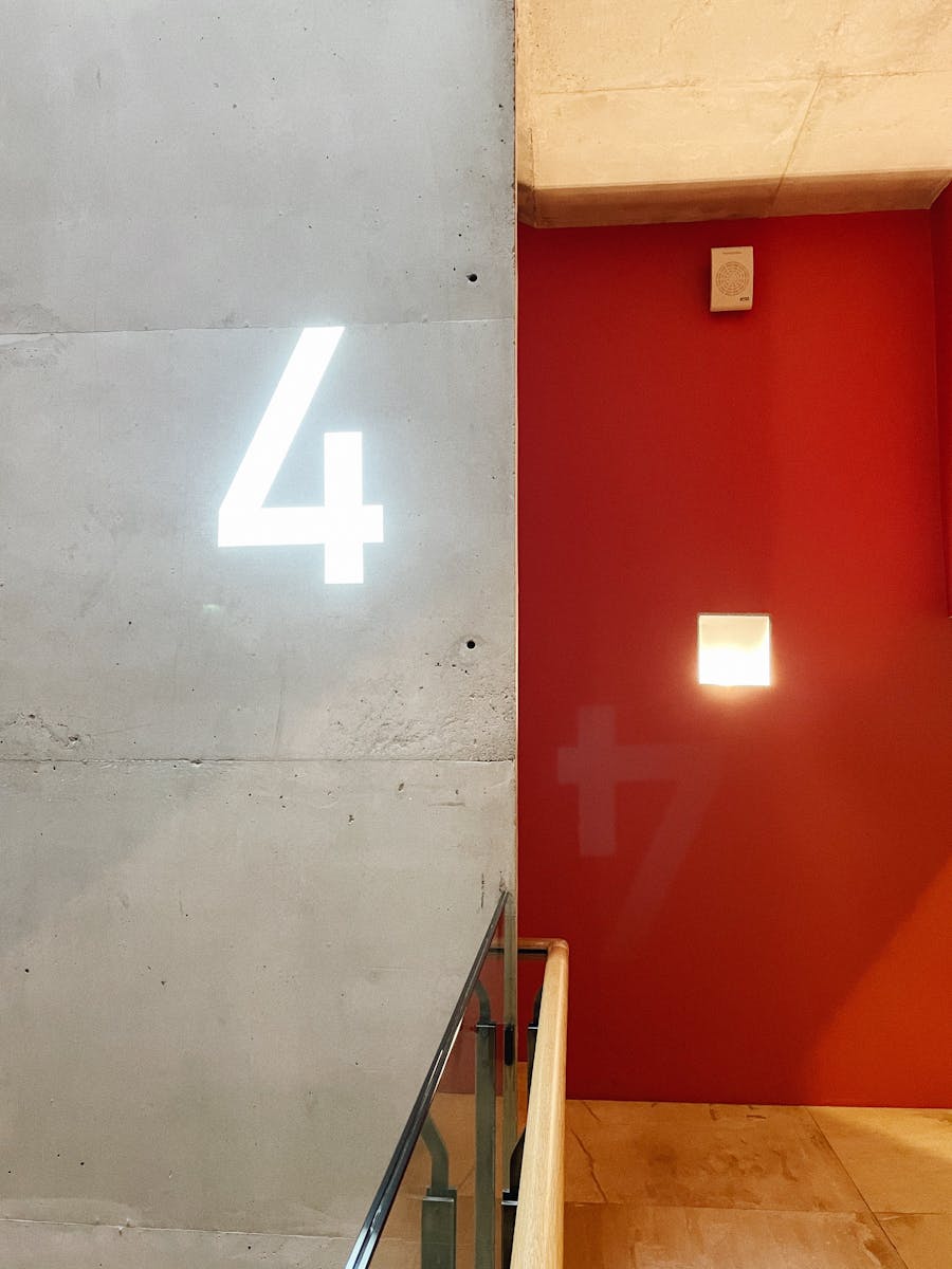 Contemporary interior featuring an illuminated number 4 on a concrete wall in Sankt-Peterburg, Russia.