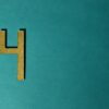 Elegant golden number four on teal background ideal for modern design.