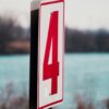 white and red number 4 signage in shallow focus photography