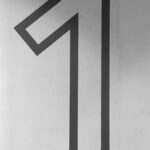 a black and white photo of a number one sign