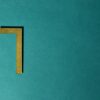 Minimalist image of a golden numeral seven on a teal background, ideal for decorative use.