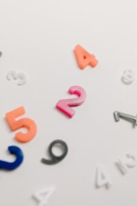 Colorful plastic numbers scattered on a white surface, great for educational themes.