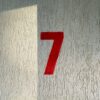 a red number seven on a white wall