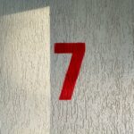 a red number seven on a white wall