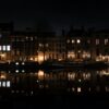 lighted building near body of water during night time