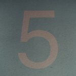 a close up of a number five on a wall